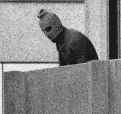 A Palestinian terrorist holds members of the Israeli Olympic team hostage at their quarters at the Munich athletes’ village in 1972.