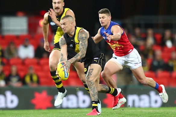 Dustin Martin eludes Brisbane's Dayne Zorko.