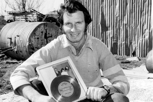Steven Walls with a gold record of the song 'Little Boy Lost' at his farm near Guyra in 1981.