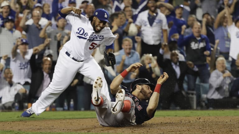 LA pitcher Pedro Baez sees Boston's Ian Kinsler tagged out at home plate.
