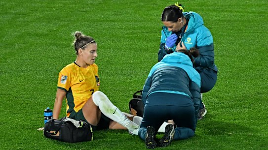 Steph Catley receives medical attention after going down midway through the first half against Denmark.