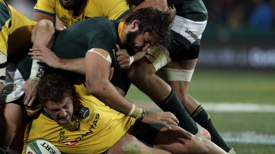 James Slipper, bottom, is tackled by South Africa's Lood de Jager,