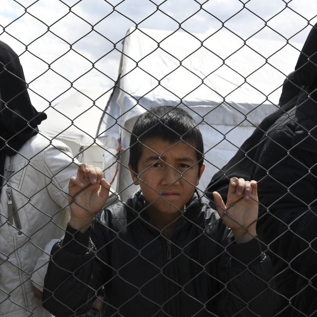 Foreign ISIS wives and children at the fence line of the Foreign section of al-Hawl camp.