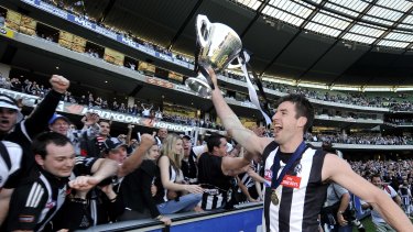 Darren Jolly celebrates winning the 2010 AFL premiership with Collingwood.