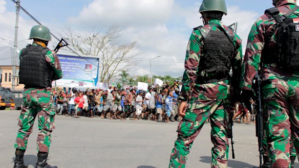 Indonesian soldiers stand guard during a protest in Timika, Papua province.