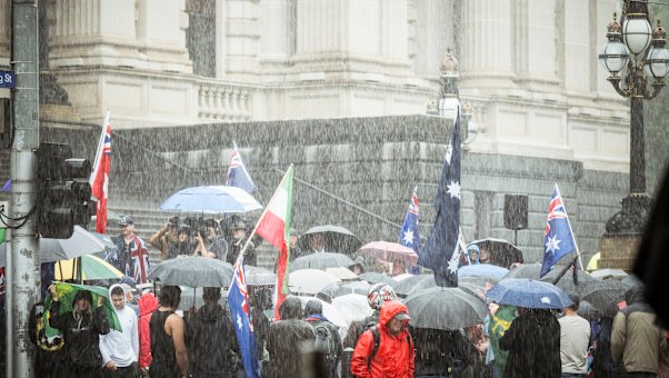 Heavy rain falls at the rally.