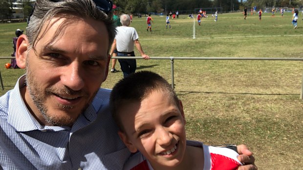 Greens MP Michael Berkman with his son, Noah, at a junior football match. 