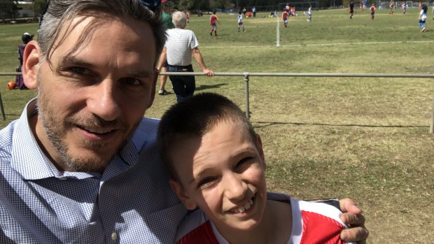 Greens MP Michael Berkman with his son, Noah, at a junior football match. 