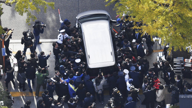 A car carrying "Twitter Killer" Takahiro Shiraishi leaves a Tokyo police station in November.