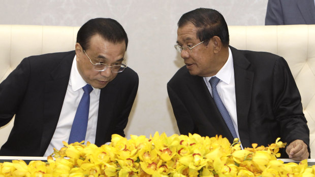 Closer ties: China's Premier Li Keqiang, left, talks with his Cambodian counterpart Hun Sen, during a signing ceremony at Peace Palace in Phnom Penh, on January 11. 