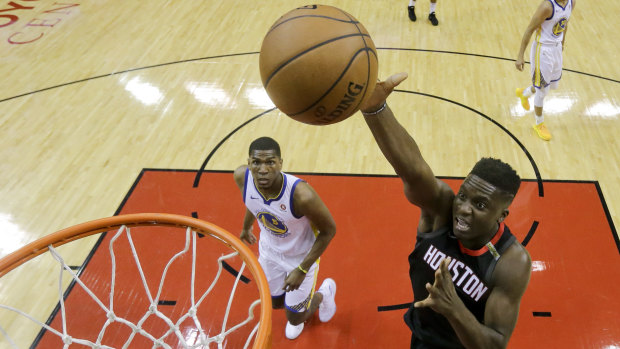The Rockets' Clint Capela (right) scores against the Warriors.