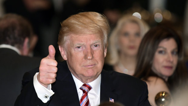 Donald Trump gives a thumbs-up as he has Thanksgiving Day dinner at Mar-a-Lago.