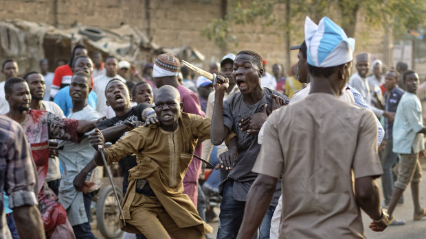 Supporters of the ruling party and main opposition party in Nigeria briefly pull knives and machetes on each other in Kano on Monday.