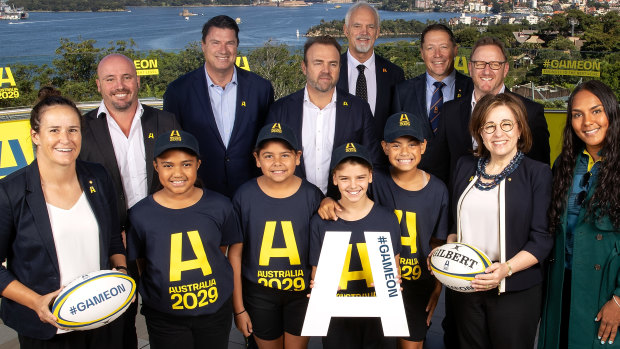 (L to R) Shannon Parry of the Wallaroos, Wallaroos head coach Jay Tregonning, Rugby Australia chair Hamish McLennan, Rugby Australia CEO Andy Marinos, RA president David Codey, Phil Kearns of the bid team, World Rugby CEO Alan Gilpin, Josephine Sukkar and Mahalia Murphy of the Wallaroos pose with junior rugby players during an Australian Rugby World Cup bid event at Taronga Zoo.