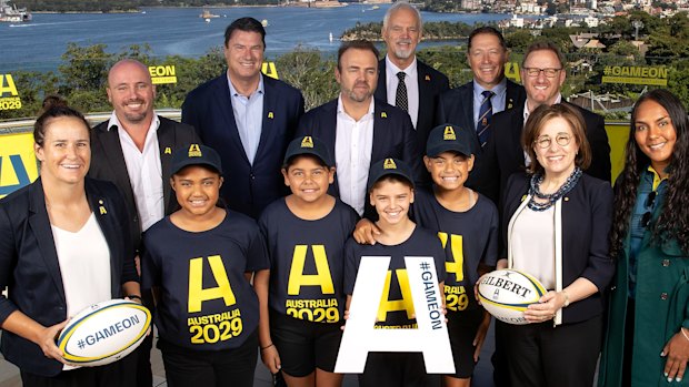 (L to R) Shannon Parry of the Wallaroos, Wallaroos head coach Jay Tregonning, Rugby Australia chair Hamish McLennan, Rugby Australia CEO Andy Marinos, RA president David Codey, Phil Kearns of the bid team, World Rugby CEO Alan Gilpin, Josephine Sukkar and Mahalia Murphy of the Wallaroos pose with junior rugby players during an Australian Rugby World Cup bid event at Taronga Zoo.