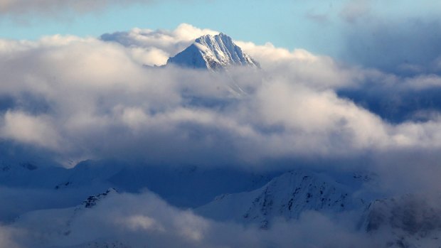 A view of Mount Aspiring's peak through the clouds on New Zealand's South Island.