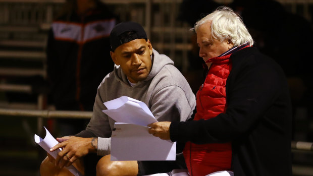 Clive Palmer and Israel Folau discuss their options at Owen Park on the Gold Coast.