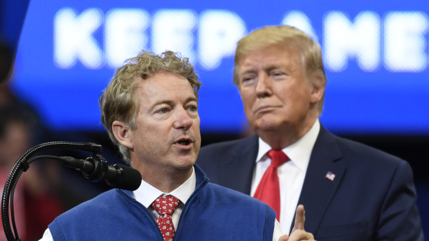 US President Donald Trump listens as Senator Rand Paul speaks during a campaign rally. 