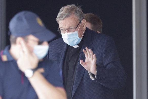 Cardinal George Pell waves as he arrives in Rome following a flight from Australia.