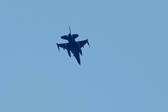 An Israeli warplane flies over the city of Tyre, south Lebanon on Wednesday.