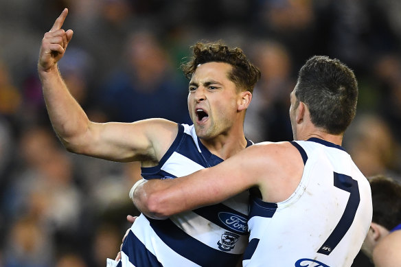 Geelong's Luke Dahlhaus, left, celebrates with Harry Taylor on the way to victory on Friday night.