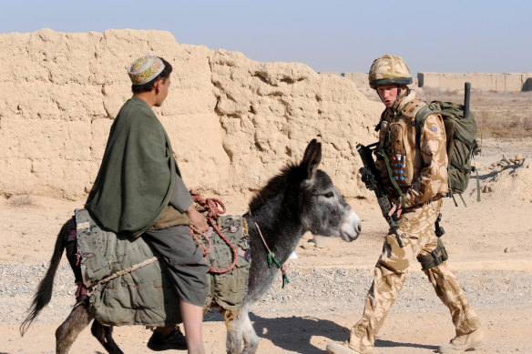 Prince Harry patrols through the deserted town of Garmisir, Afghanistan in 2008.