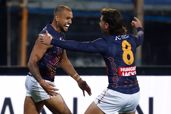 Callum Ah Chee (left) and Josh Rachele of the Crows celebrate a goal earlier this season.