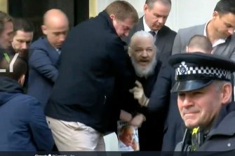 Julian Assange is carried from the Ecuadoran embassy on Thursday.