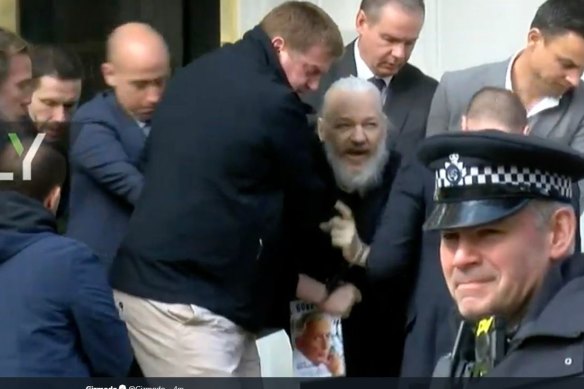 Julian Assange is carried from the Ecuadoran embassy on Thursday.