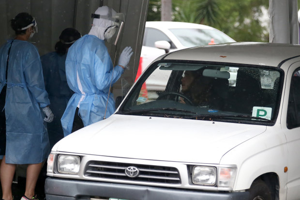 A worker tests a resident at a drivethrough COVID-19 test centre in Brisbane on Friday.