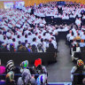 A recent service of the Plymouth Brethren Christian Church showing women at the back of the room, men at the front.