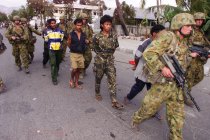 Australian soldiers detain suspected members of the Aitarak militia at their compound in 1999.