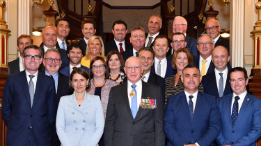 NSW Premier Gladys Berejiklian and her new ministry pose for a photo with NSW Governor David Hurley at Government House in Sydney.