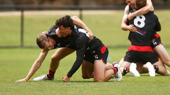 Massimo D’Ambrosio and Will Setterfield wrestle at Essendon training recently.