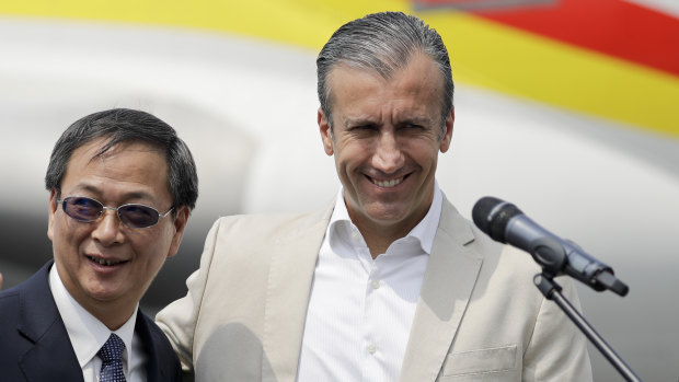 Chinese Ambassador Li Baorong, left, and Tareck El Aissami, Venezuela's minister of industry and national production, arrive to talk to reporters at the Simon Bolivar International Airport in Maiquetia, near Caracas, Venezuela.
