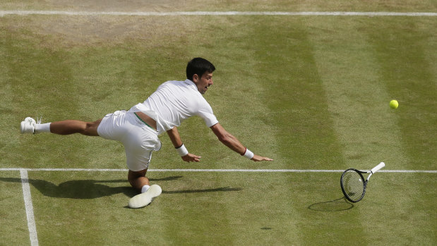 Djokovic falls while attempting to return a ball during the semi-final on Friday.