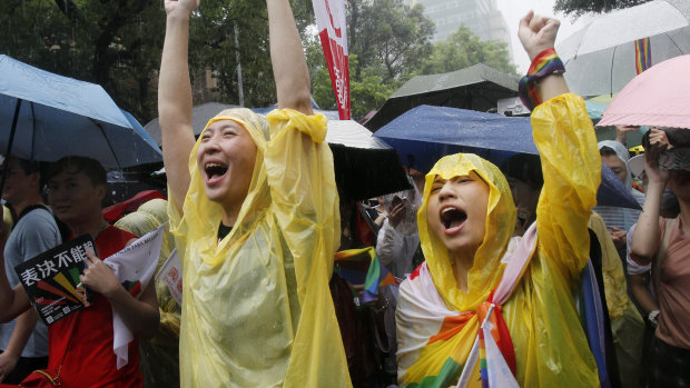 Same-sex marriage supporters cheer outside the Legislative Yuan in Taipei, Taiwan, on Friday.
