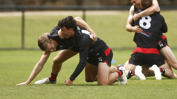 Massimo D’Ambrosio and Will Setterfield wrestle at Essendon training recently.
