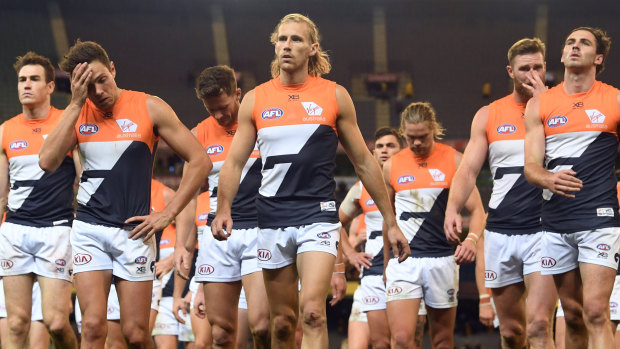 The Giants leave the field after putting up feeble resistance to Hawthorn on Sunday.