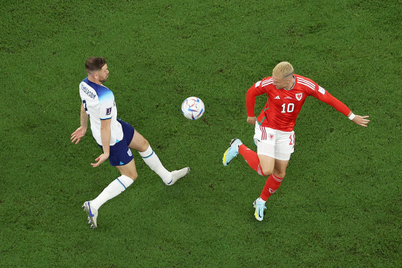 England’s Jordan Henderson and Aaron Ramsey of Wales battle for the ball.