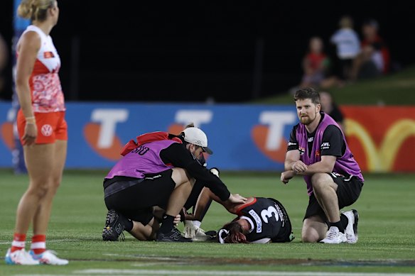 Alice Burke is seen to by St Kilda medical staff during their game against the Swans in Coffs Harbour.