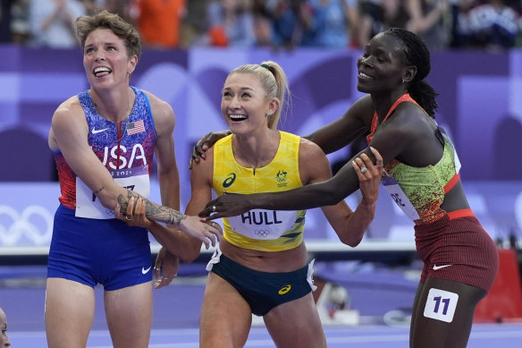 Nikki Hiltz (left) and Susan Lokayo Ejore congratulate Jess Hull on her silver medal.