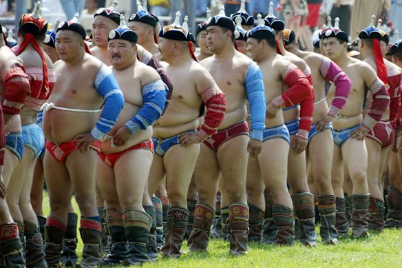 Wrestlers await their bouts in Mongolia.