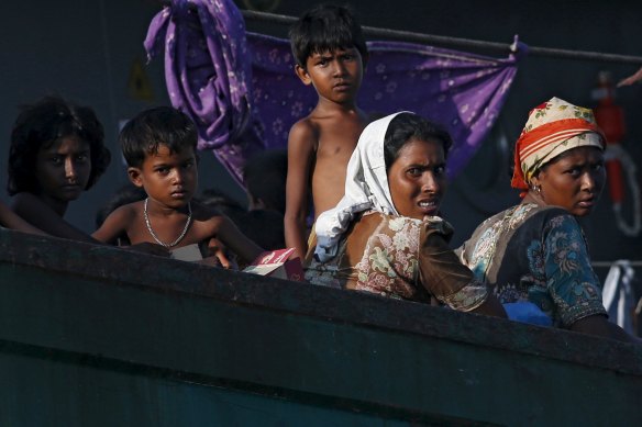 Migrants on a boat tethered to a Thai navy vessel in waters near Koh Lipe island in May 2015. 