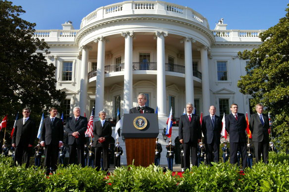 U.S. President George W. Bush (C) speaks during a ceremony at the White House in 2004 marking the expansion of NATO’s membership from 19 countries to 26.