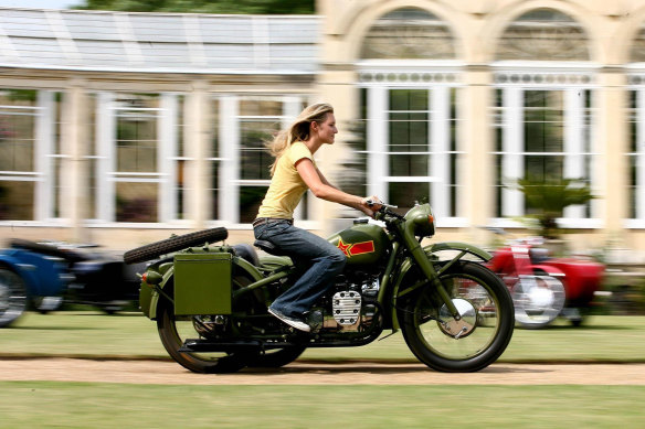 Lady Katie Percy  riding a Chang Jiang imported Chinese motorbike at Syon House, London. 