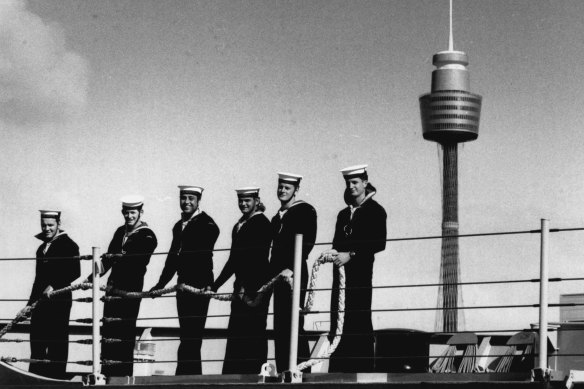 Sailors on the deck of the Darwin as the ship pulls out.