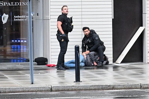 The suspect was shot and killed and a second person believed to be the attendant is in critical condition.