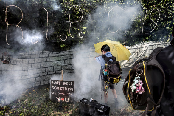 "Save me from the stinky smoke," said Henry Burke, nine, using a yellow umbrella as a force field of sorts, as he played with his friend Guna Kudipudi, eight, outside the Frederikson family's Halloween display on Archbold Road, Roseville. 