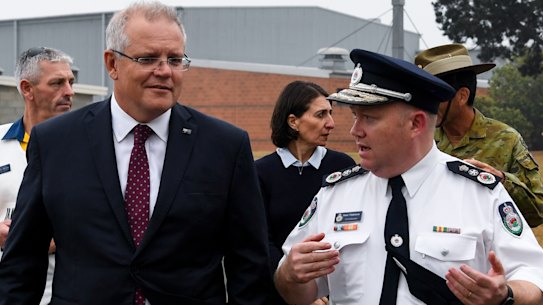 Prime Minister Scott Morrison speaks to RFS Commissioner Shane Fitzsimmons during a visit to HMAS Albatross in Nowra on Sunday